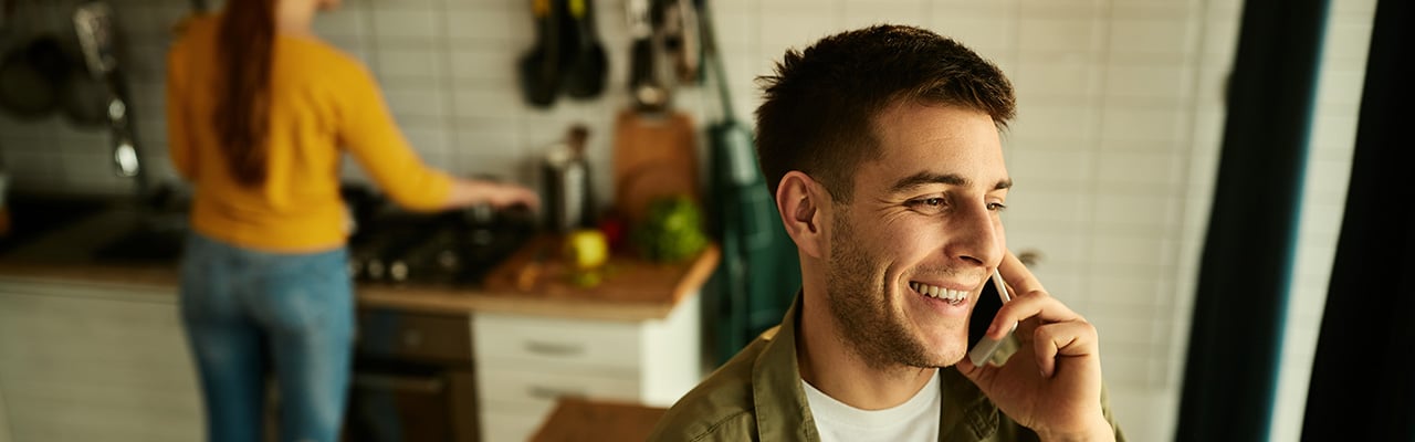 Man on phone at home – contact Urban Digital for Audio Visual services
