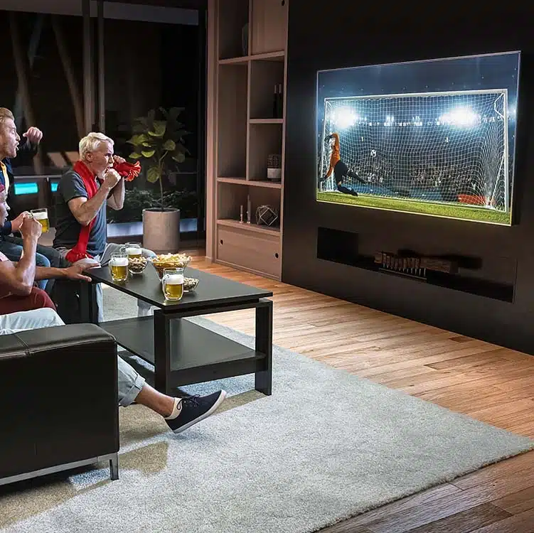 Modern living room with media wall TV setup and friends watching football match