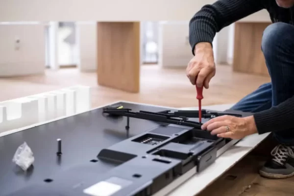 Technician assembling TV wall mount bracket
