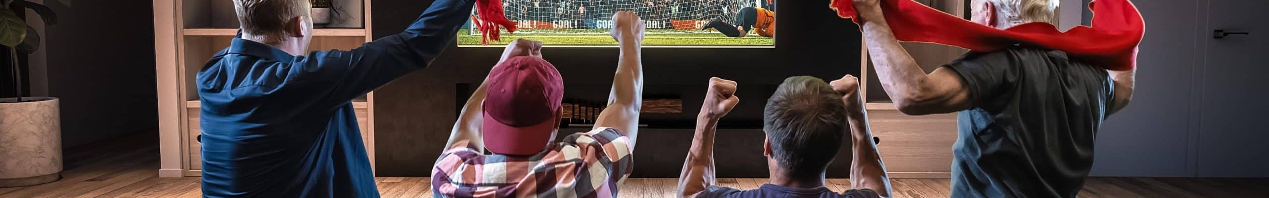Modern living room with media wall TV setup and friends watching football match